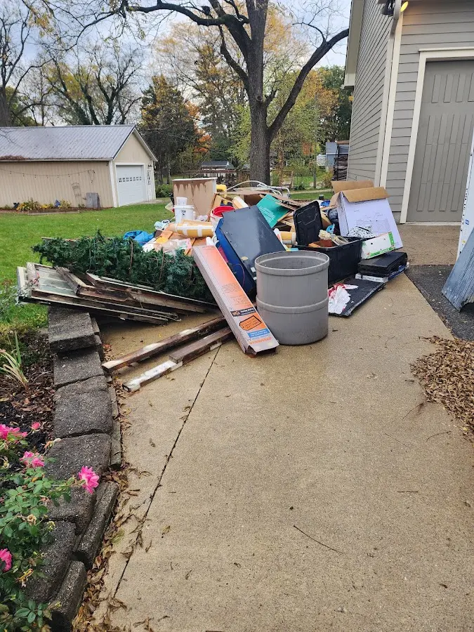 Dumpster being loaded with debris for Estate Cleanout Dumpster Rental in Pratt